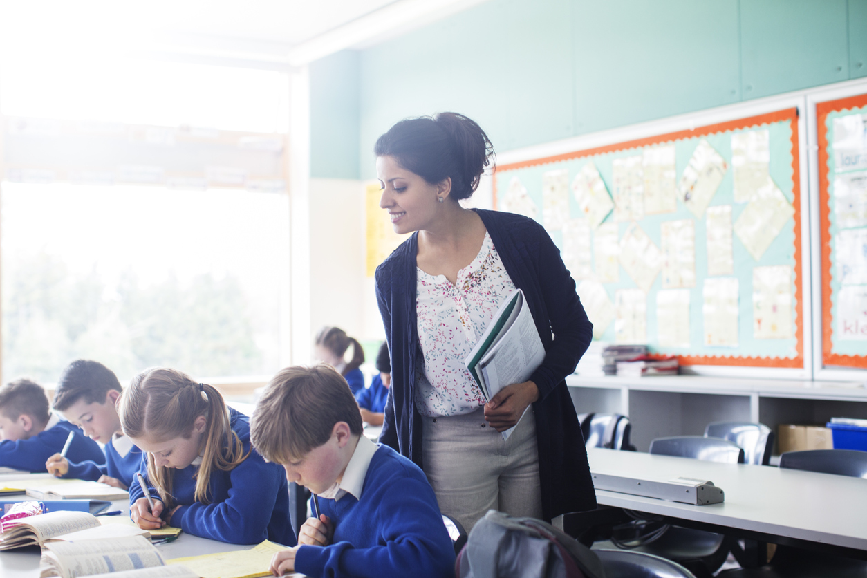 Female teacher with her pupils in classroom