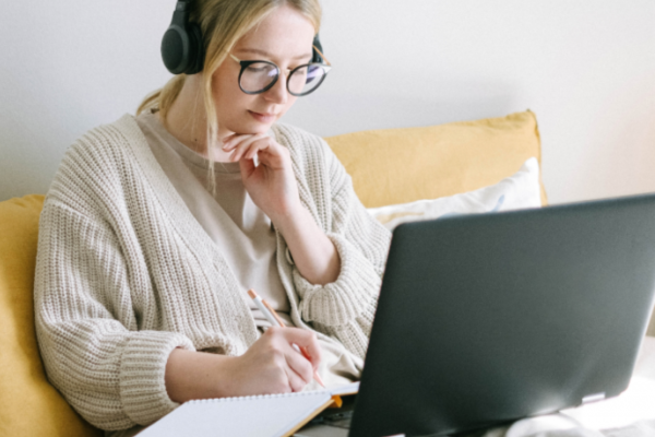 A woman listening at her computer